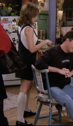 a man sitting in a chair next to a woman on the set of friends like us