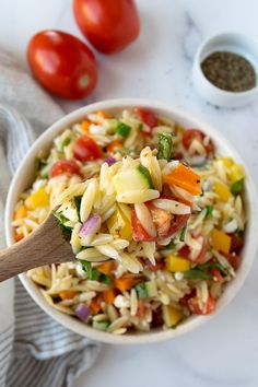 Rainbow Orzo Salad on a wooden spoon with a big bowl of rainbow orzo salad in the background. Colorful Salad, Best Pasta Salad, Orzo Salad, Salad Side Dishes, Mediterranean Diet Recipes, Pasta Salad Recipes, Side Salad, Orzo, Mediterranean Recipes