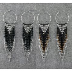 three pairs of black and gold beaded hoop earrings with dangling chains hanging from them