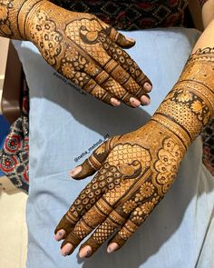 two hands with henna designs on them