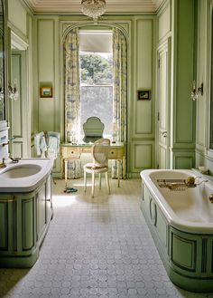 a bathroom with two sinks and a bathtub in the middle, along with a chandelier hanging from the ceiling