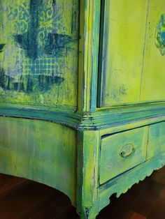 an old dresser painted green and blue