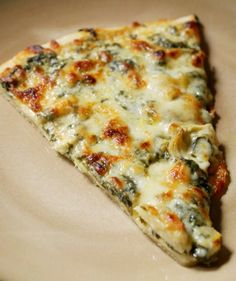 a slice of pizza sitting on top of a white plate