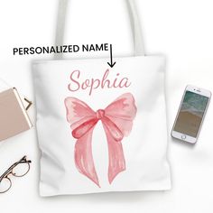 Choose which side to display based on your mood with this trendy, double-sided personalized coquette bow tote bag in two different-sized prints.  A large pink coquette bow graphic and your custom name on one side of the bag and a small pink bow pattern on the other side. The bows were originally hand-painted in watercolor by me for that one-of-a-kind artisan look.  Personalize this pink coquette bow tote bag with either your custom name or initials. Available in a variety of colors, the coquette Tote Bag Painting Ideas Coquette, Croquette Tote Bag, Trendy Tote Bag With Bow, Cute Pink Bag With Bow, Elegant Bow Tote Shoulder Bag, Bow Tote Bag, Bow Graphic, Roommate Gifts, Personalized Bow