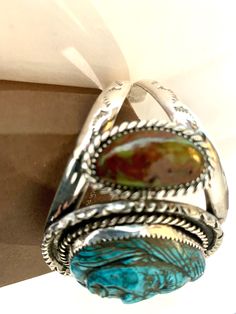 beautiful ring by Spanish silversmith/lapidartist/master carver, Francisco Gomez. It is completely hand wrought in sterling silver. It is set with a turquoise that is hand carved in the image of an Native American Brave. wonderful one of a kind piece. Francisco Gomez - Each of his pieces are made by his own hands as well as all of the carvings. He is a master silversmith, lapidartist and carver who has been in the business for over 43 years. He is known for his fantastic Native American style pi Artisan Engraved Turquoise Ring Collectible, Southwestern Polished Turquoise Ring Collectible, Artisan Bangle Jewelry Collectible, Unique Adjustable Turquoise Ring With Polished Finish, Adjustable Gemstone Cuff Bracelet Collectible, Artisan Carved Jewelry For Collectors, Artisan Carved Jewelry For Collectibles, Unique Carved Collectible Jewelry, Unique Carved Jewelry For Collectors