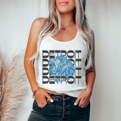 a woman wearing a white shirt with the detroit detroit lions on it