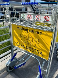 a shopping cart sitting on the side of a road with no parking signs attached to it