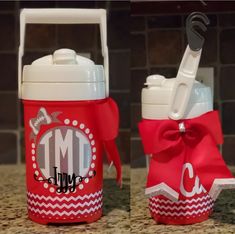 a red and white water bottle with a monogrammed ribbon tied around the lid