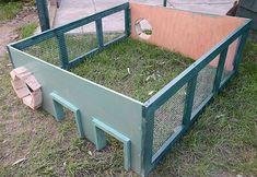 an outdoor area with grass in the middle and a fence around it, including a chicken coop