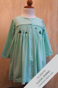 Girl’s Dress Sewing Pattern Sizes 3-12. Rosie is a simple smocked or gathered dress with buttons down the front that can be made in an easy-care, comfortable knit, or a great woven for today's girl. And of course Rosie has pockets for all her treasures. Rosie may be made with smocked skirts (front and back or just the front), a gathered high yoke, or a gathered mid-yoke. Rosie also comes with a choice of long or short sleeves. Rosie is available as a paper or PDF pattern. Long Sleeve Cotton Smocked Dress For Fall, Green Cotton Winter Dresses, Long Sleeve Cotton Smocked Dress With Smocked Cuffs, Fitted Cotton Smocked Dress, Fall Cotton Smocked Back Dress, Fall Cotton Smocked Dress, Fall Cotton Dresses With Smocked Back, Long Sleeve Cotton Smocked Dress For Spring, Long Sleeve Cotton Dress With Smocked Bodice