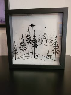 a black and white frame with a christmas scene in it