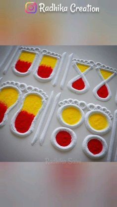 the cake is decorated with red, yellow and white icing