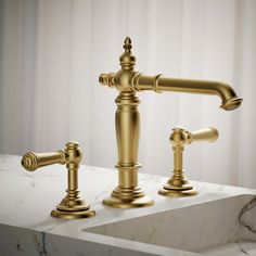 a golden faucet on a marble counter top