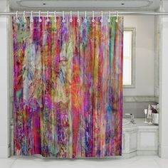 a colorful shower curtain hanging in a bathroom