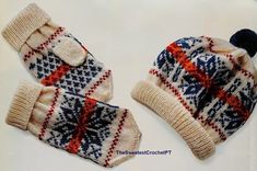 two knitted hats and mittens sitting on top of a white table next to each other