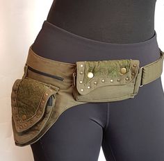 Utility pocket belt in army green Adjusts to 48 inch hip/waist measurement. Gold tone metal hardware & lace detail. 5 pocket design. Have your hands free while on the go! Biking, shopping, at concerts & events, traveling, biking & more. Fantastic gift for a friend or family member. See my whole collection of pocket belts here: https://www.etsy.com/ca/shop/VintageindiaCA?ref=seller-platform-mcnav&section_id=34445559 Exactly as shown in photos. What you see is what you get. In stock and ready to s Green Utility Bags With Pockets, Green Utility Bag With Pockets, Military Style Green Bags With Pockets, Military Green Bags With Pockets, Military Style Khaki Bag With Pockets, Khaki Military Style Bag With Pockets, Steampunk Utility Belt, Travel Money Belt, Rave Dance