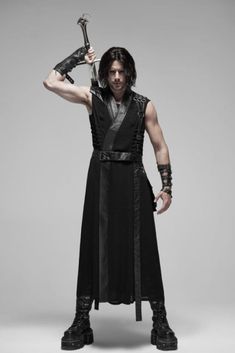 Fulfill your anime cosplay fantasy with this awesome punk warrior long vest.  This long vest falls to mid calf on most men.  Vest has faux leather trim on the collar and all the way down the front.  Vest has faux leather detailing on both shoulders, including attached and loose straps that hold the belt and… Black Warrior Cosplay Costume For Fantasy Events, Sleeveless Cosplay Costume For Halloween, Sleeveless Halloween Cosplay Costume, Black Post-apocalyptic Cosplay Costume, Black Warrior Cosplay Costume For Larp, Steampunk Vest For Halloween Cosplay, Black Gothic Vest For Alternative Fashion, Gothic Sleeveless Vest For Costume Party, Fitted Sleeveless Cosplay Costume