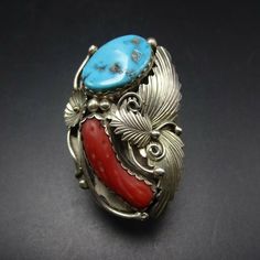 "VINTAGE NAVAJO RING DESCRIPTION: This spectacular ring features Sleeping Beauty turquoise and old red Mediterranean branch coral. The gemstones are secure in scalloped bezel, on a foundation of heavy gauge vintage sterling silver. Highly detailed applied leaves enhance the face of the ring. This impressive ring will be a treasured addition to your collection of fine vintage Native American jewelry. MEASUREMENTS: Ring face measures 2\" x 1 1/4\" Turquoise cabochon measures 20mm x 13mm RING SIZE: Red Inlay Ring Jewelry, Red Inlay Ring, Red Ring With Inlay, Vintage Red Gemstone Jewelry, Red Heirloom Jewelry For Collectors, Vintage Hallmarked Red Ring, Vintage Red Hallmarked Ring, Vintage Turquoise Ring With Inlay For Anniversary, Red Vintage Jewelry With Cabochon