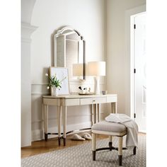 a white dressing table with a mirror and stool