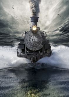 a steam engine train traveling through the ocean