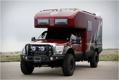 a red truck with a camper on the back