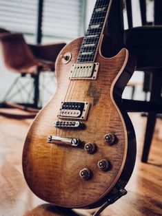 an electric guitar sitting on top of a hard wood floor