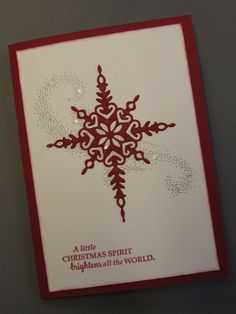 a red and white christmas card with a snowflake