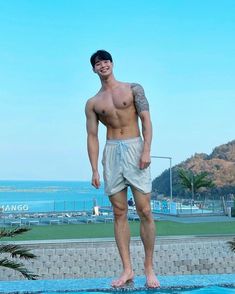 a man standing on the edge of a swimming pool