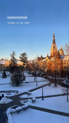 an image of a snowy day in the city with trees and buildings on either side