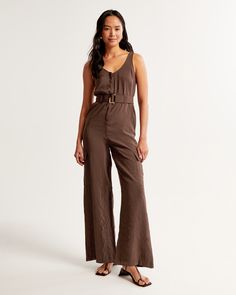 Elevate your wardrobe with the Abercrombie & Fitch Women's Draped Utility Jumpsuit, a perfect blend of style and functionality. This jumpsuit is designed to flatter, crafted from a comfortable, drapey fabric that gracefully contours your figure.

- **Size**: XS TALL
- **Color**: Dark Brown
- **Material**: Body made from Viscose and Polyester
- **Gender**: Female
- **Features**: Scoop neckline with wide straps, adjustable belt, wide-leg pants, utility-style cargo pockets

Ideal for both casual ou Womens Black Jumpsuit, Utility Jumpsuit, Wrap Skort, Sequin Rompers, Petite Jumpsuit, Casual Rompers, Wide Leg Linen Pants, Striped Rompers, Sleeveless Rompers