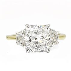 an oval cut diamond ring with three stone shoulders