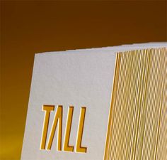 a close up of a business card with the word tail on it's side