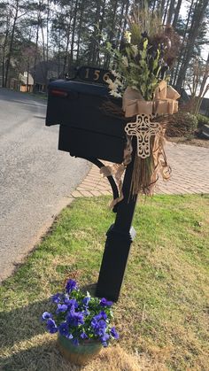 a mailbox decorated with flowers and ribbons