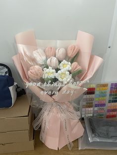 a bouquet of flowers sitting on top of a table next to some boxes and other items