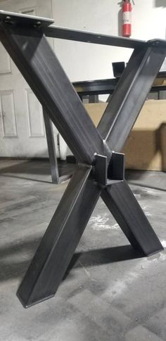 a metal table sitting on top of a cement floor