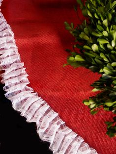 a bouquet of flowers sitting on top of a red cloth