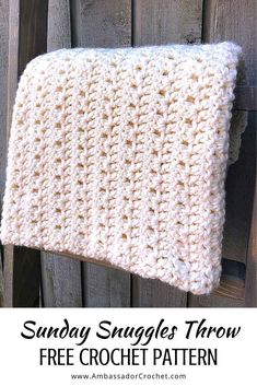 a crocheted dishcloth hanging on a wooden fence with text overlay that reads, sandy snuggles throw free crochet pattern