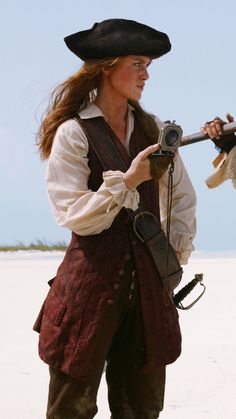 a woman dressed in pirate clothing holding a camera