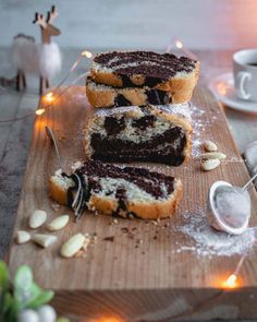 three pieces of cake sitting on top of a wooden cutting board