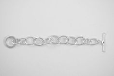 My friend Alana has been in my book group for 27 years. Her silver link bracelet that I have always admired is the inspiration for this bracelet. Three individual link styles and a custom toggle come together to create this stunning bracelet. Wear it alone or stack it with other bracelets for an arm party! Sterling silver 8" long