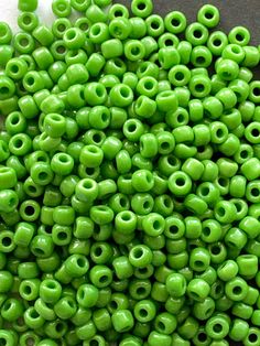 green beads with holes in them on a table