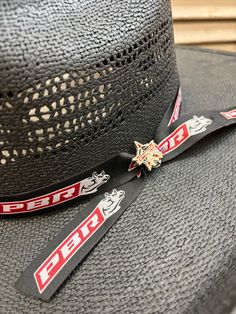 Support your favorite PBR cowboys with the Bullhide No Pressure Black Straw Cowboy Hat. A perfect cowboy hat to wear to any rodeo event, it has a 4 1/2" brim and a 4 3/4" cattleman's crown bordered with a Professional Bull Rider's ribbon band and hat pin. Note: As a natural product, palm straw may vary in color so hat may be different than in picture. Professional Bull Riders, Rodeo Events, Country Strong, Straw Cowboy Hat, Western Store, Bull Riders, Western Cowboy Hats, Cowgirl Western, Western Hats