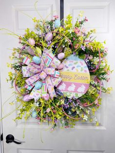 an easter wreath is hanging on the front door