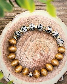 Beautiful and simple Dalmatian Jasper and wood beaded bracelet. Wooden Beaded Bracelets With Round Beads, Handmade Beaded Wood Bracelets In Natural Wood Color, Wooden Beaded Bracelets Perfect For Gifts, Bohemian Wood Beaded Bracelets, Handmade Adjustable Beaded Bracelets In Natural Wood, Handmade Natural Wood Beaded Bracelets, Handmade Adjustable Natural Wood Beaded Bracelets, Handmade Wooden Beaded Bracelets, Rustic Wooden Beads Bracelet