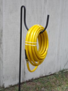 a yellow hose is attached to the side of a building