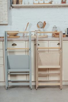 there are two wooden chairs next to each other in the kitchen counter top area, one is blue and the other is white