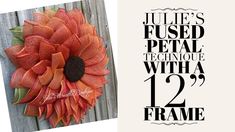 an orange sunflower on a wooden fence with the words july's fussed petal technique with a 12 % frame