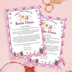 a pink and white checkered table cloth with scissors next to two cards that say santa claus