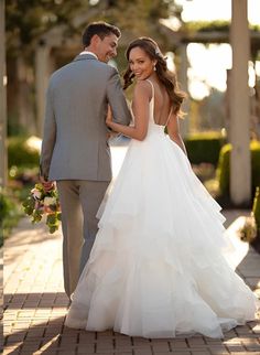 the bride and groom are standing together outside