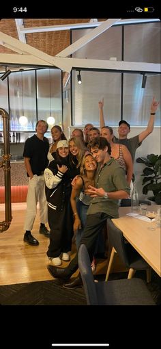 a group of people posing for a photo in front of a table with a musical instrument